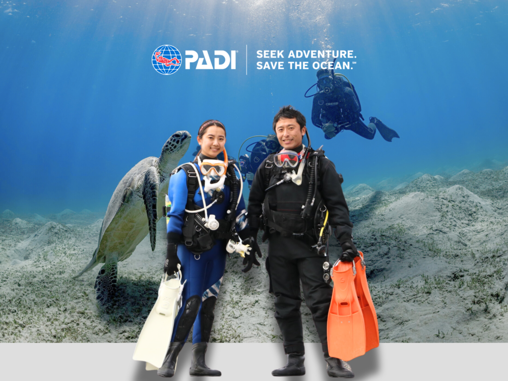 two people wearing diving gear and taking photo at photo booth