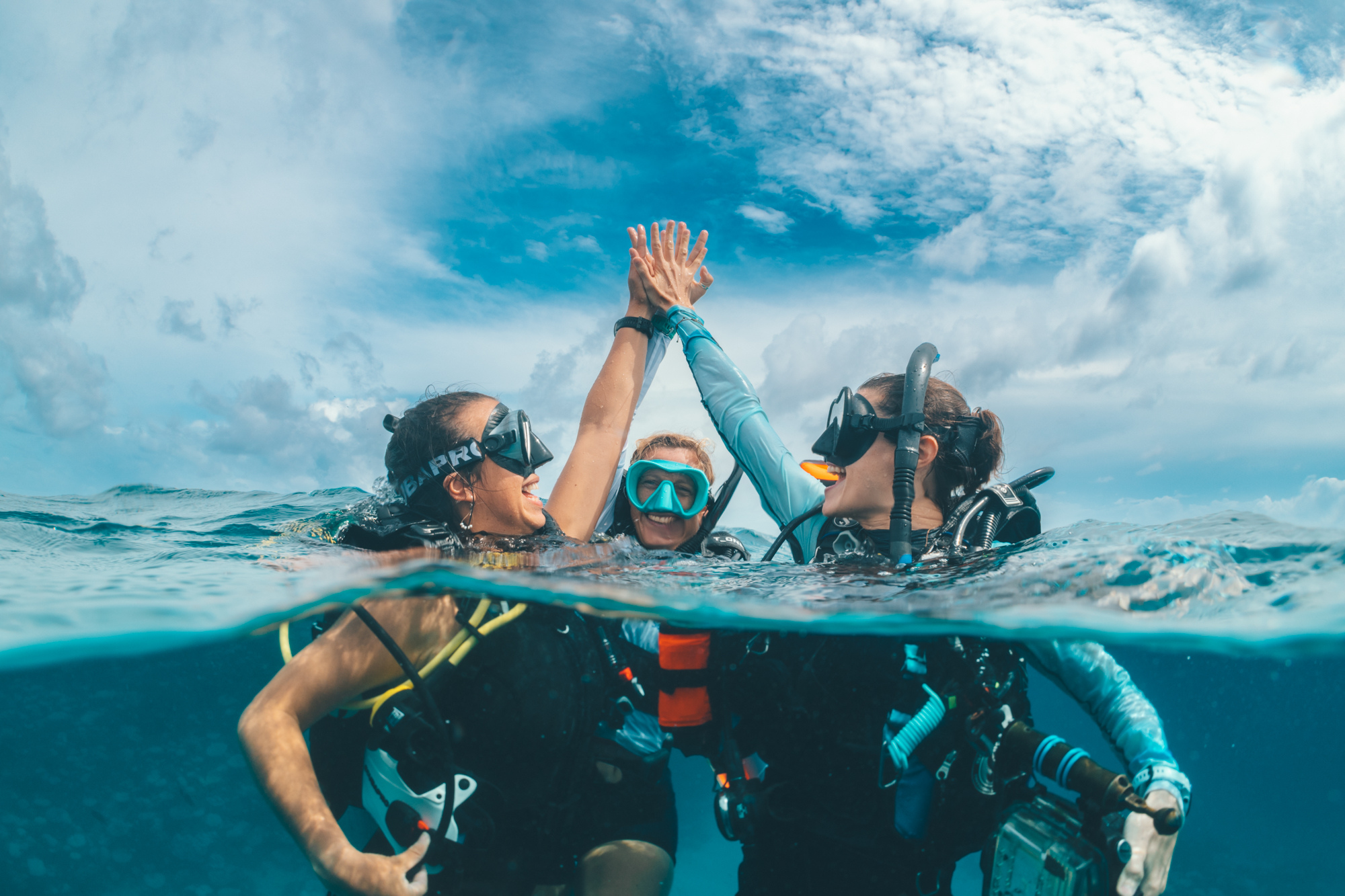 koh tao divemaster destination two divers clasp hands