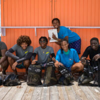 Six teenage children in Barbados complete a PADI AWARE Dive Against Debris after taking part in the Water Awareness Program