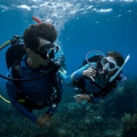 two divers communicating underwater padi