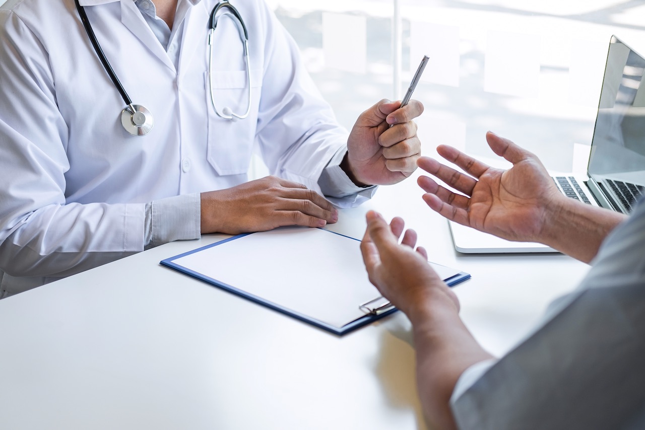 Doctor and patient are discussing consultation about symptom problem diagnosis of disease talk to the patient about medication and treatment method.