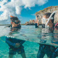 two divers communicate at the surface before a dive