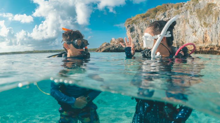 two divers communicate at the surface before a dive