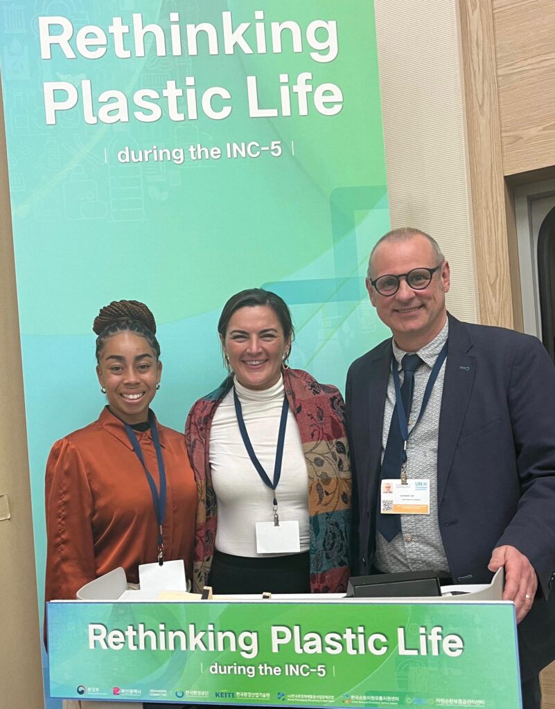 Ian Campbell and two women attend the Global Plastics Treaty negotiations in Busan, Korea