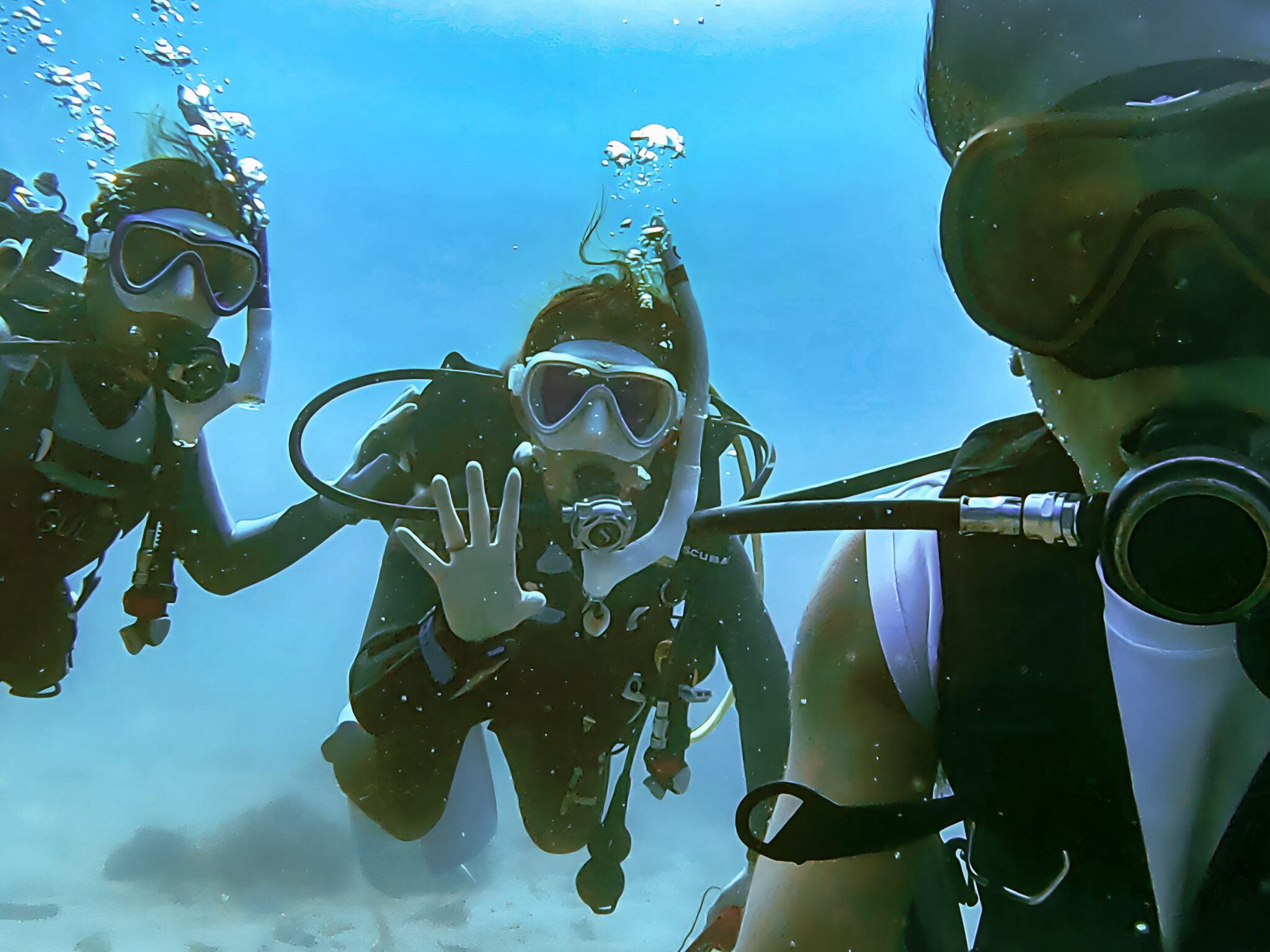 underwater selfie with three divers from the luv k raft group