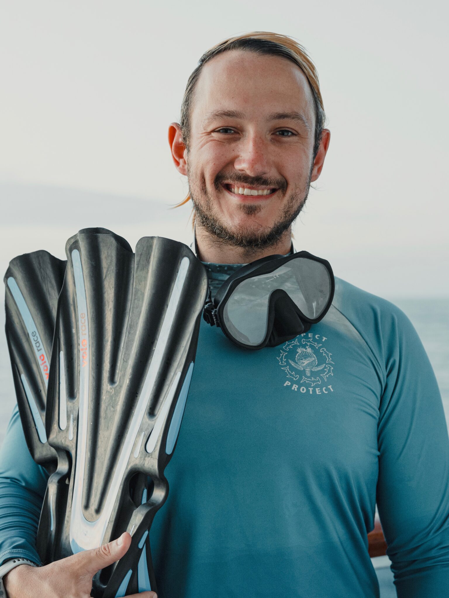 JD Reinbott holding a pair of fins