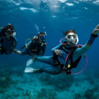 Professional diver leading divers underwater