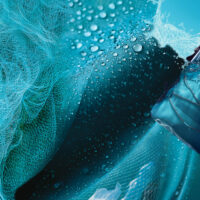 GROUNDTRUTH X PADI Waterproof Backpack pictured next to a fishing net