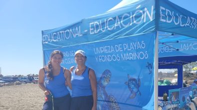 Nikky Weglop and her mother, two PADI Pros, standing in front of an underwater clean up tent
