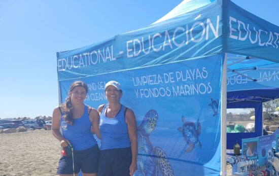 Nikky Weglop and her mother, two PADI Pros, standing in front of an underwater clean up tent