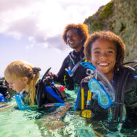 three young girls try scuba diving in Curacao with a PADI Instructor
