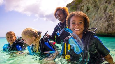 three young girls try scuba diving in Curacao with a PADI Instructor