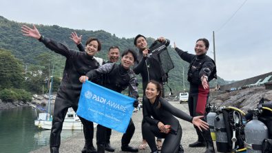 Japan AmbassaDivers and models posting for a group photo in Futo, Japan