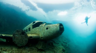 Winter ice diving underwater in a quarry in Canada