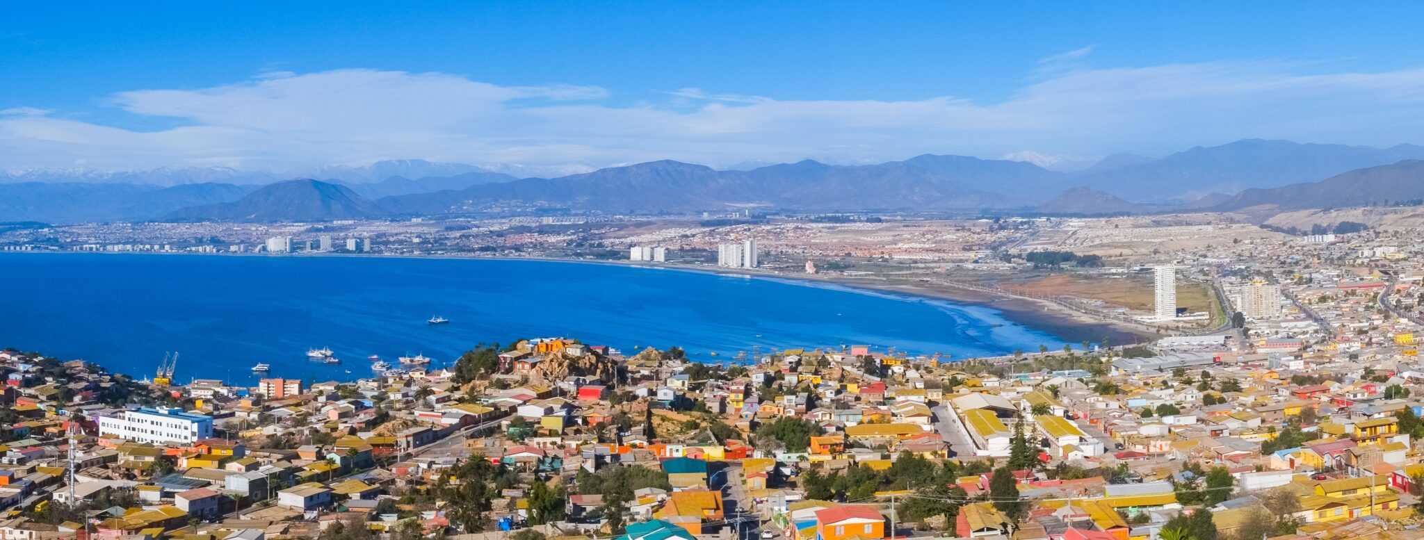 A view of the town of La Serena, Chile overlooking a blue water bay