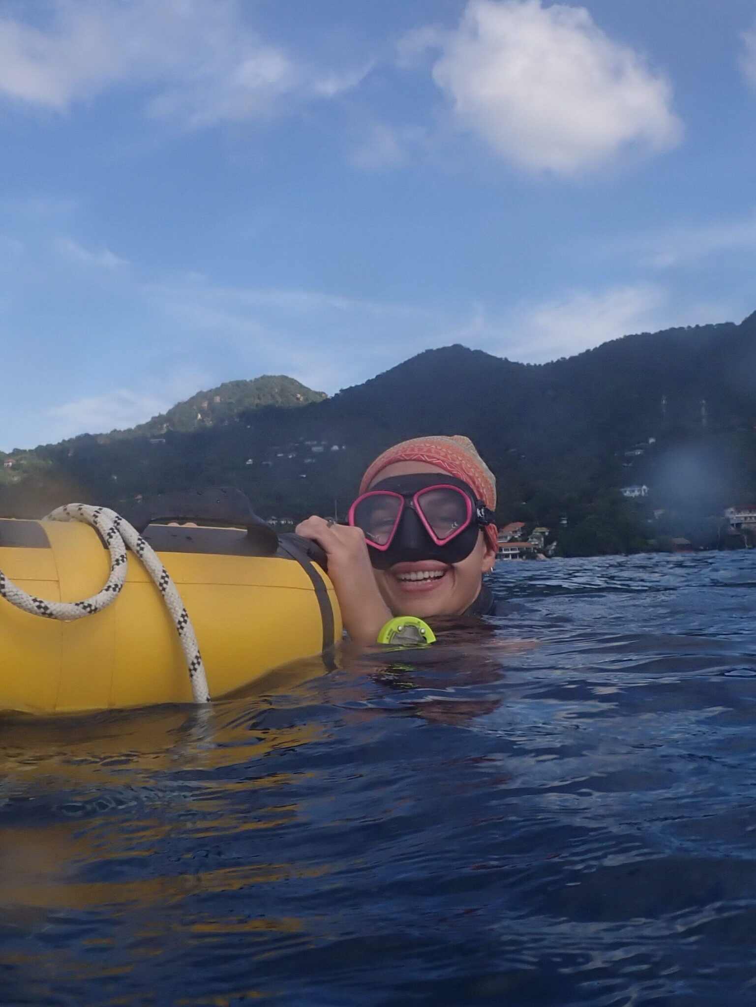 Freediver holding onto a buoy in the ocean