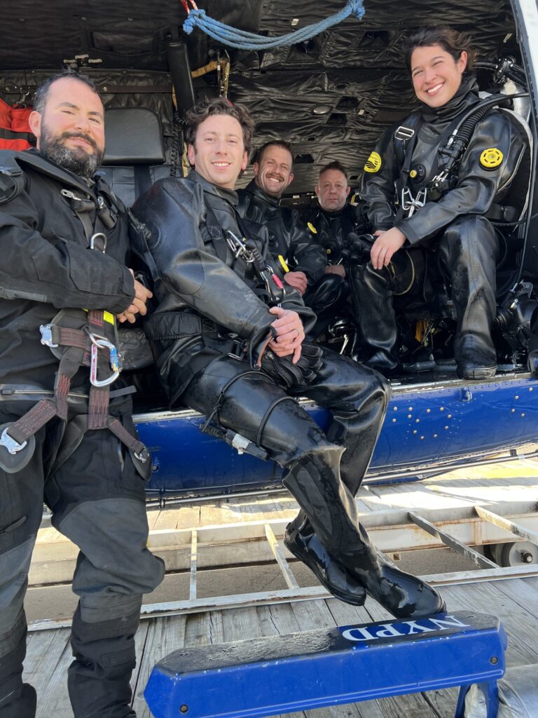 Five members of the NYPD Scuba Team wearing drysuits
