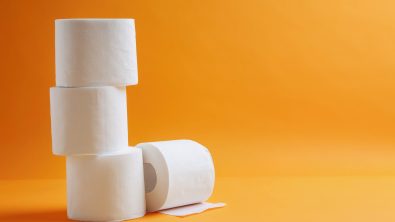 Rolls of toilet paper on color background