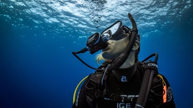 diver underwater looking towards the surface