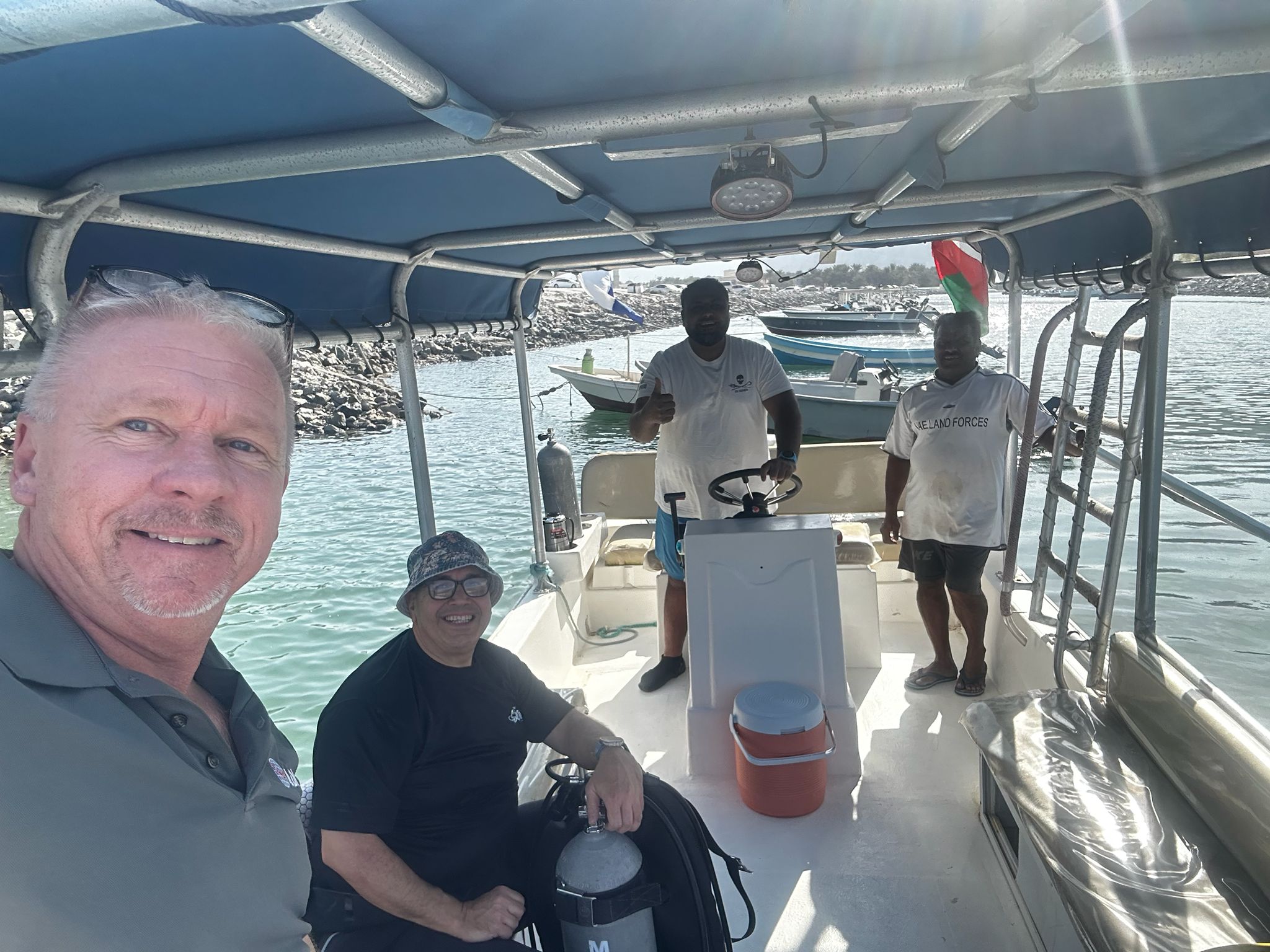 Jason Sockett and three other divers on a boat in Musandam
