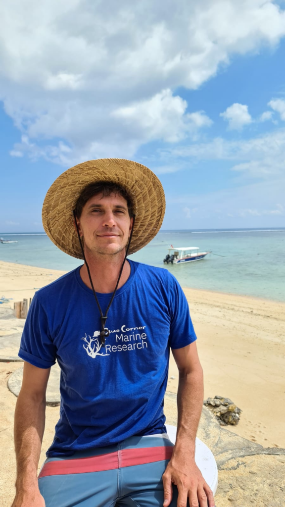 Andrew Taylor, Ocean Torchbearer Awardee, standing on a beach