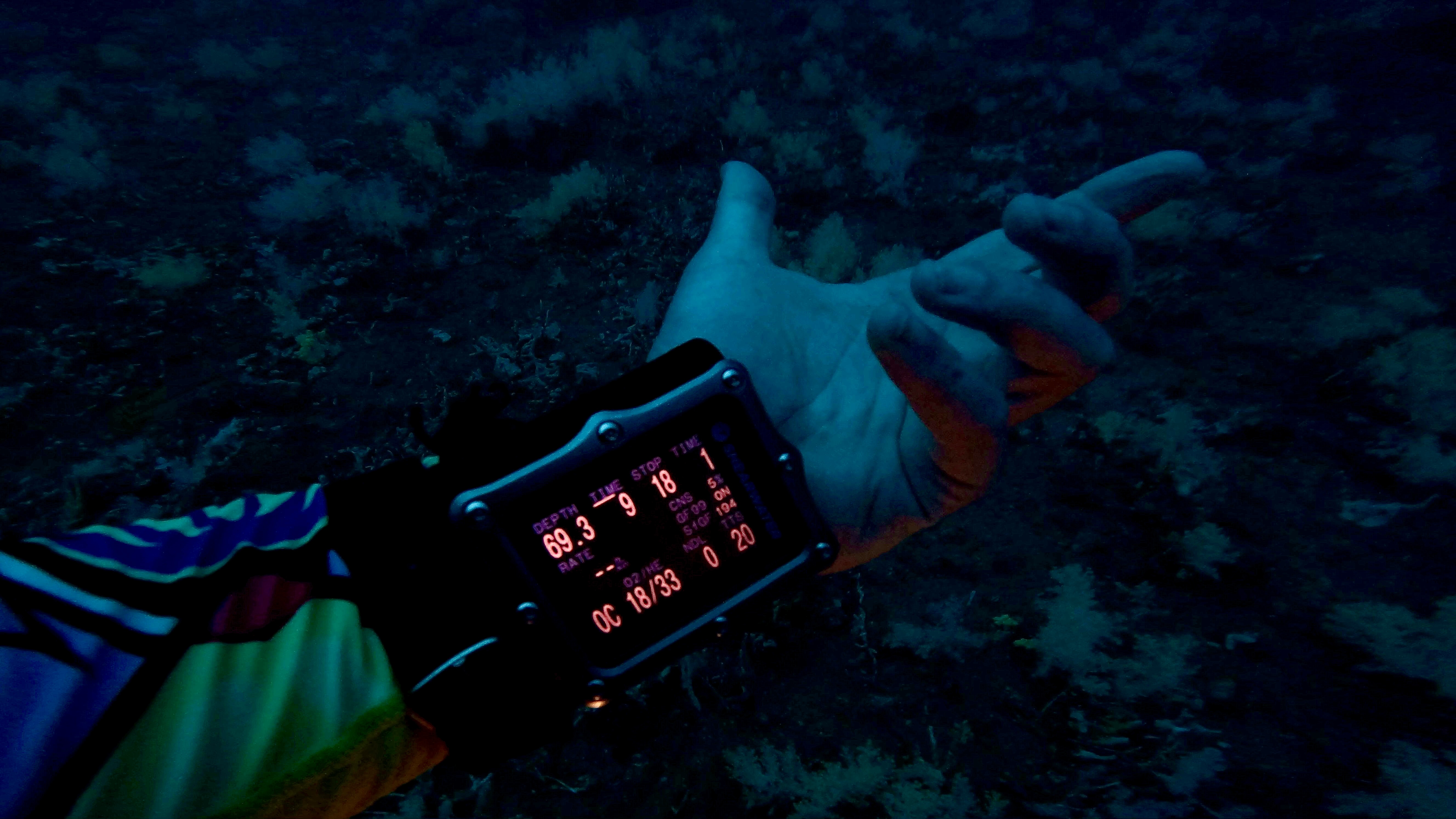 Photo of a tec dive computer showing a depth of 69 meters