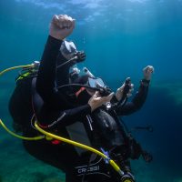 two divers practice rescue scenario underwater