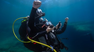 two divers practice rescue scenario underwater
