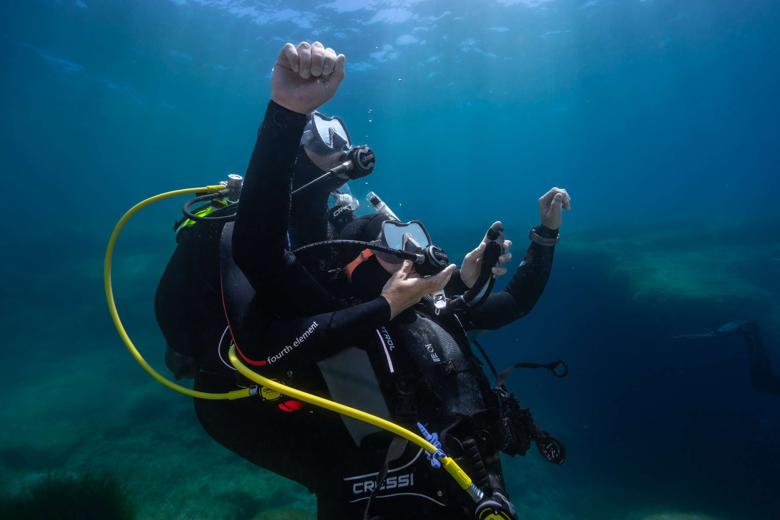 two divers practice rescue scenario underwater