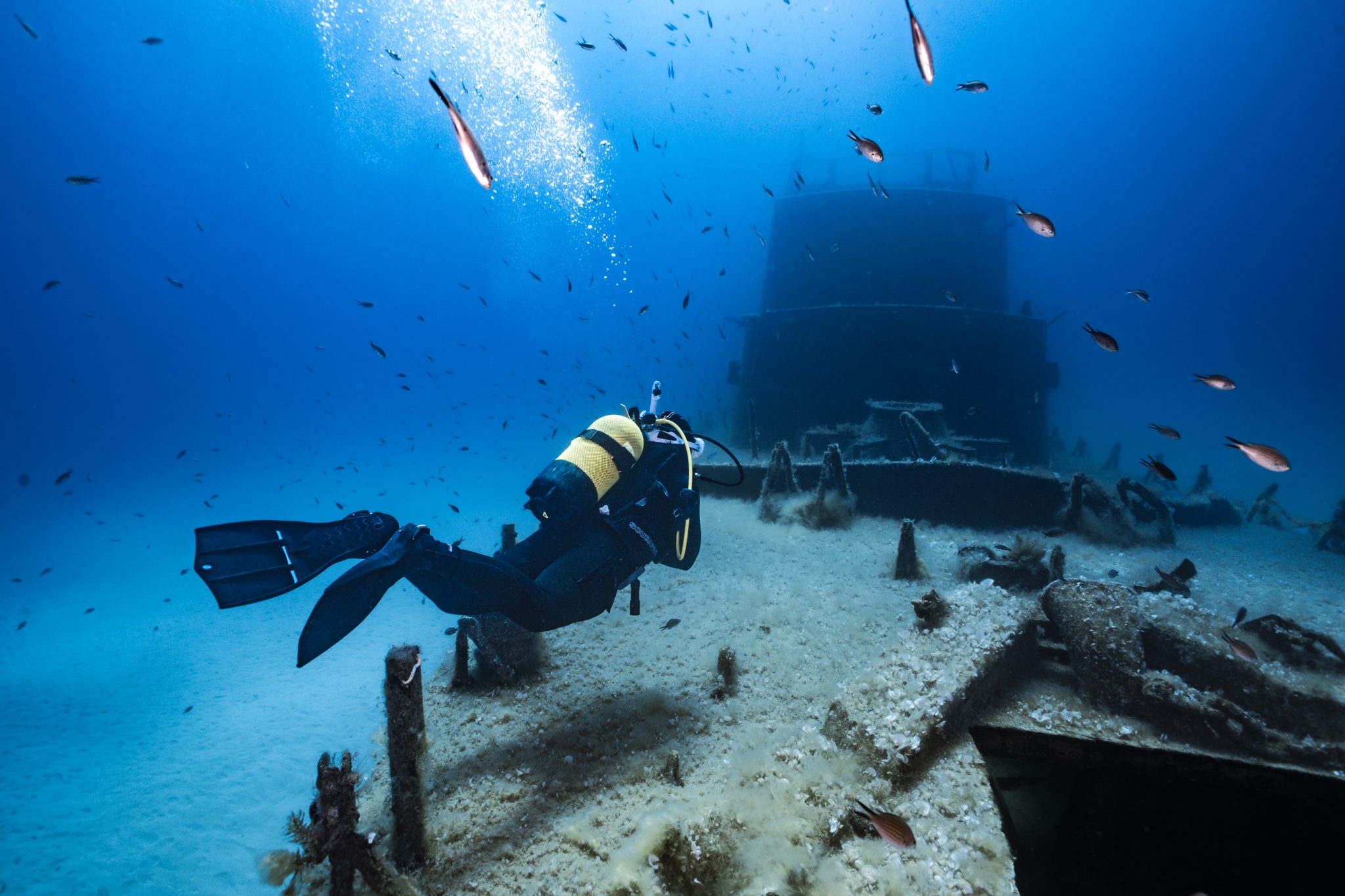 A scuba diver floats over a wreck in Malta