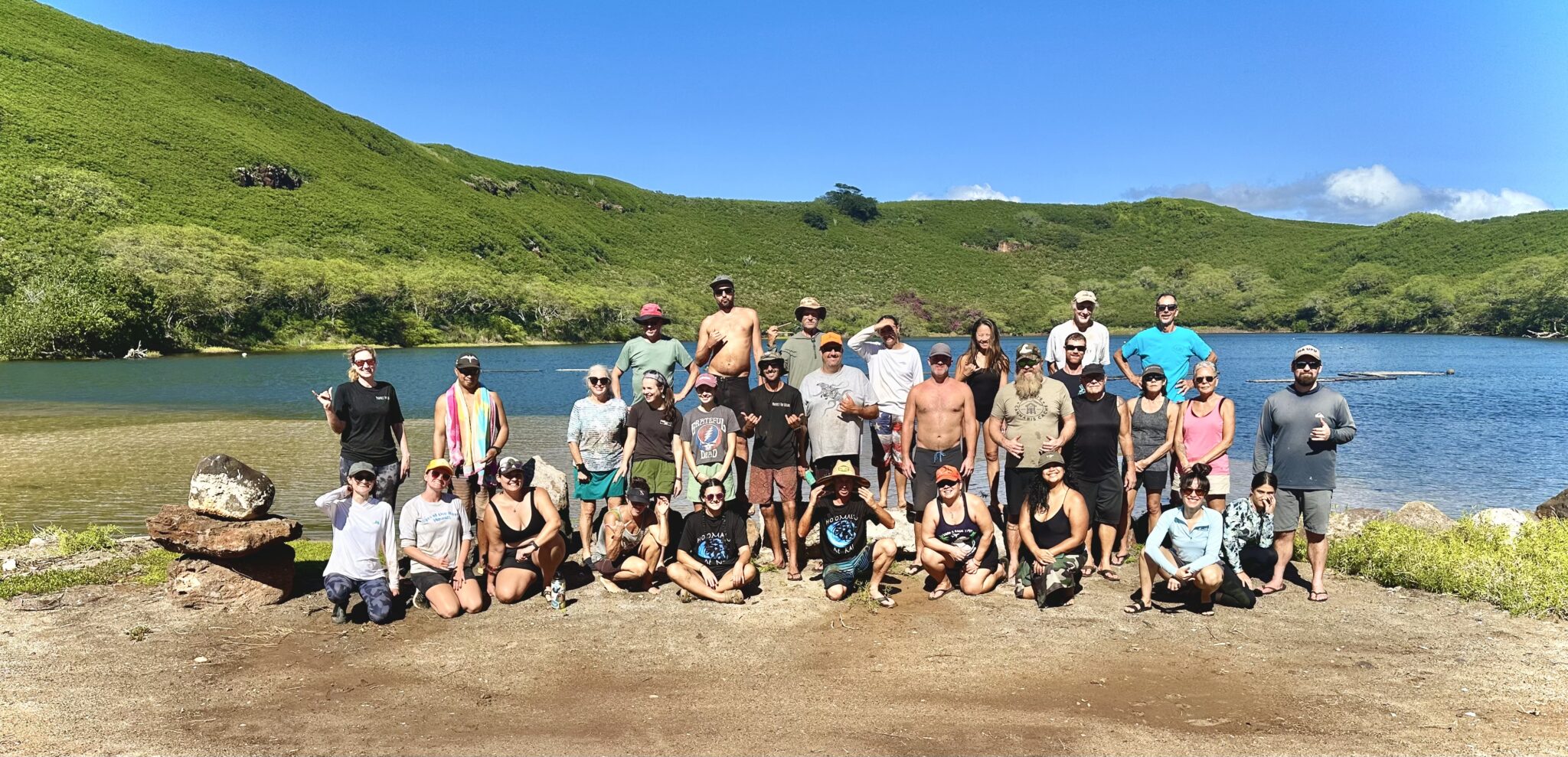 A group of people poses for the camera on a seashore in Hawaii