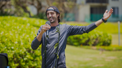 Tim Leichliter Ocean Torchbearer giving a presentation with a microphone on a lawn