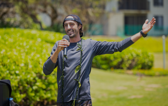 Tim Leichliter Ocean Torchbearer giving a presentation with a microphone on a lawn
