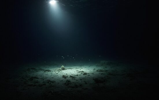 light shining down into dark water