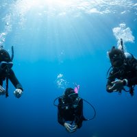 three divers complete a safety stop after a dive in Taiwan