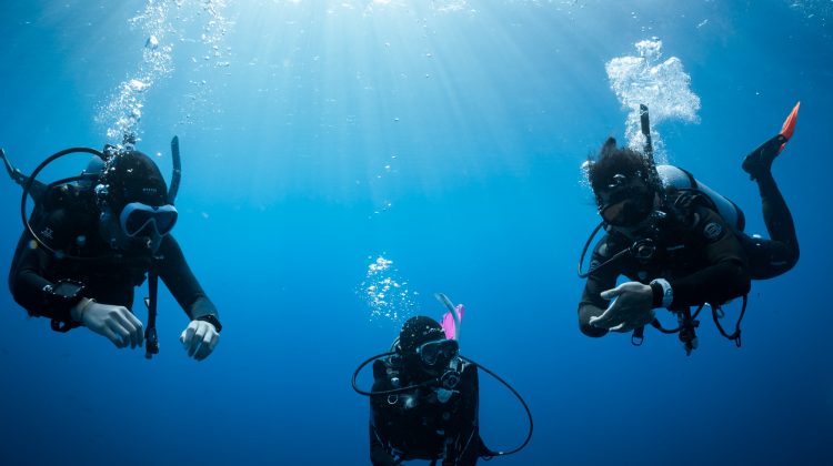 three divers complete a safety stop after a dive in Taiwan