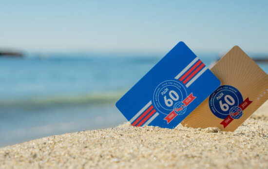 Two certification cards showing PADI's 60th anniversary logo in sand