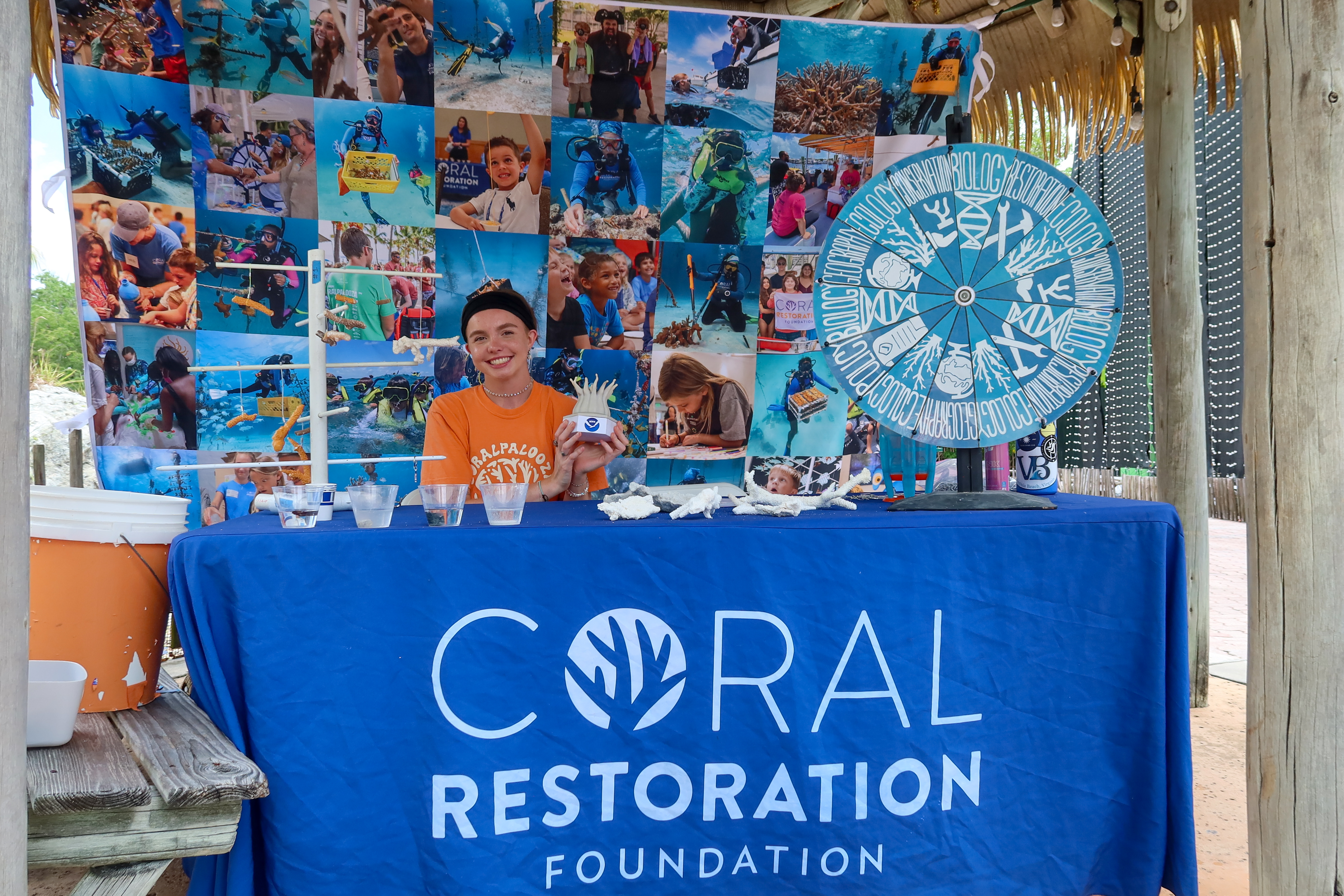 volunteer with model at a display table. Image courtesy of Coralpalooza