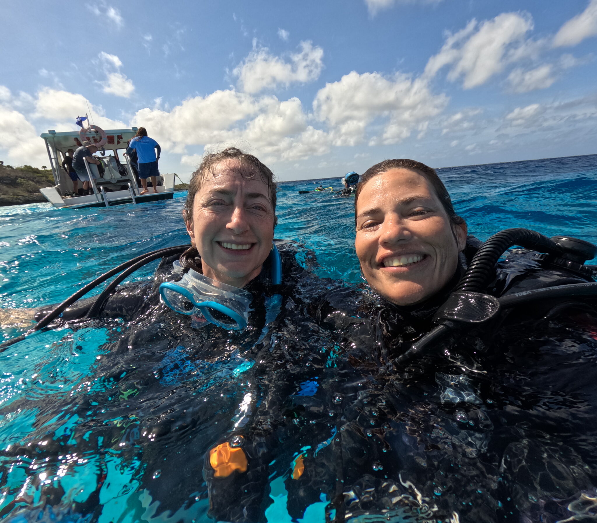 Two divers smiling at the surface in Bonaire