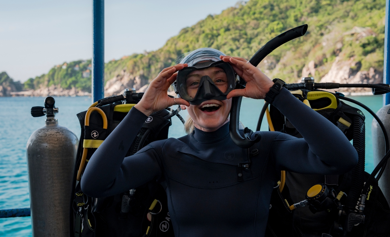 Scuba diver smiling before getting in the water.