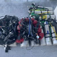 Tec diving gear layed out on the ground for two divers