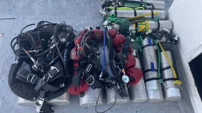 Tec diving gear layed out on the ground for two divers