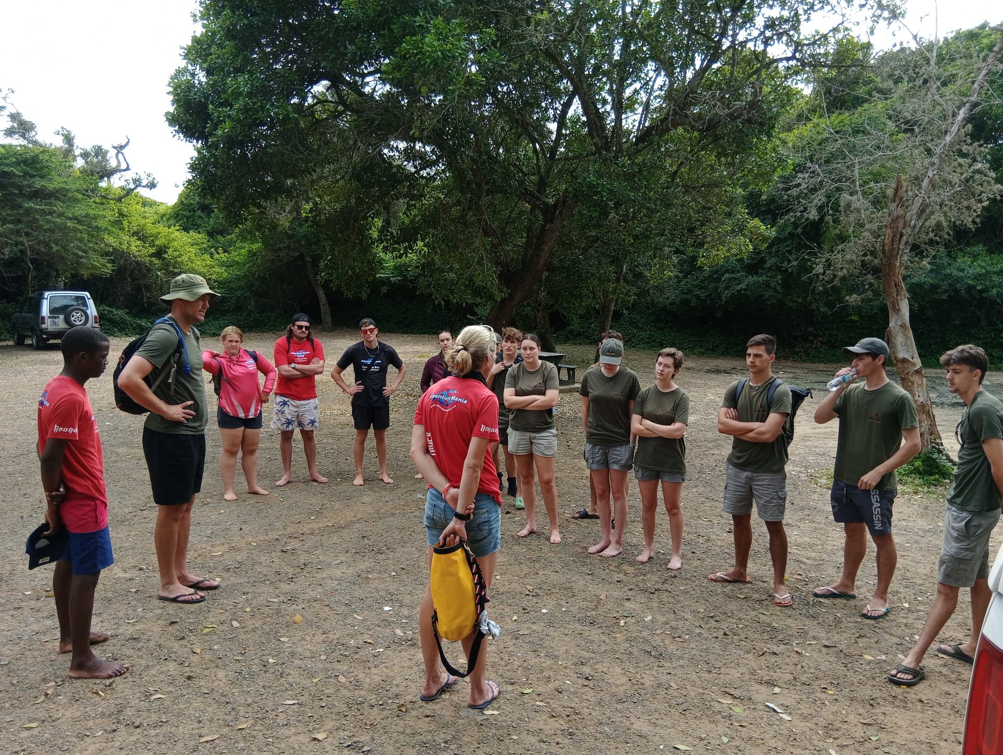 Ocean Torchbearer Award Winner Amanda Van Jaarsveld standing on a beach in front of a large group training them for a beach clean up