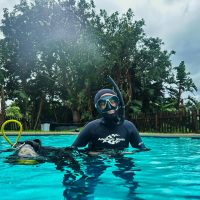 Ocean Torchbearer Award Winner Amanda Van Jaarsveld in scuba gear standing in a pool
