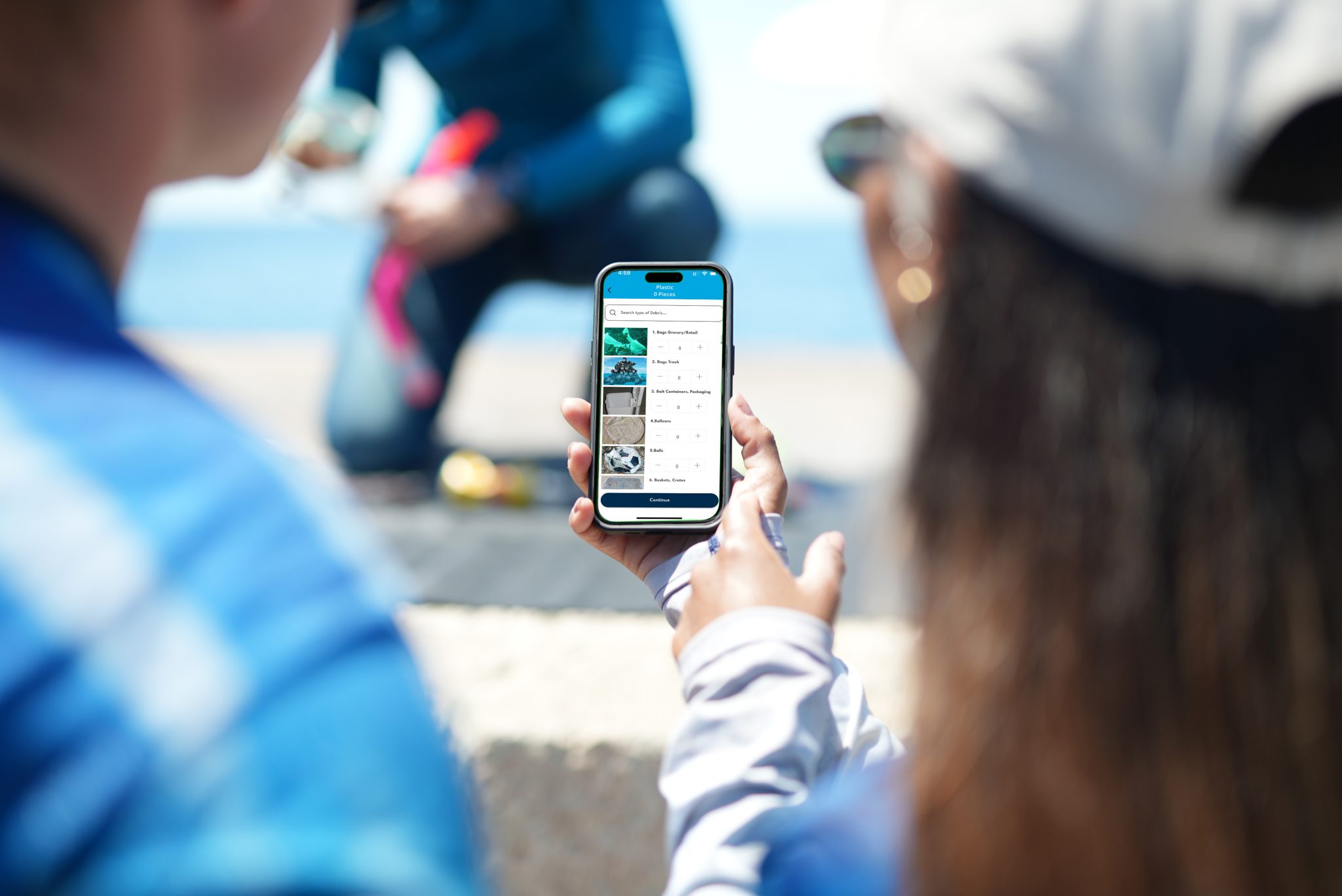 Two divers looking at the conservation Action Portal (CAP) on a phone