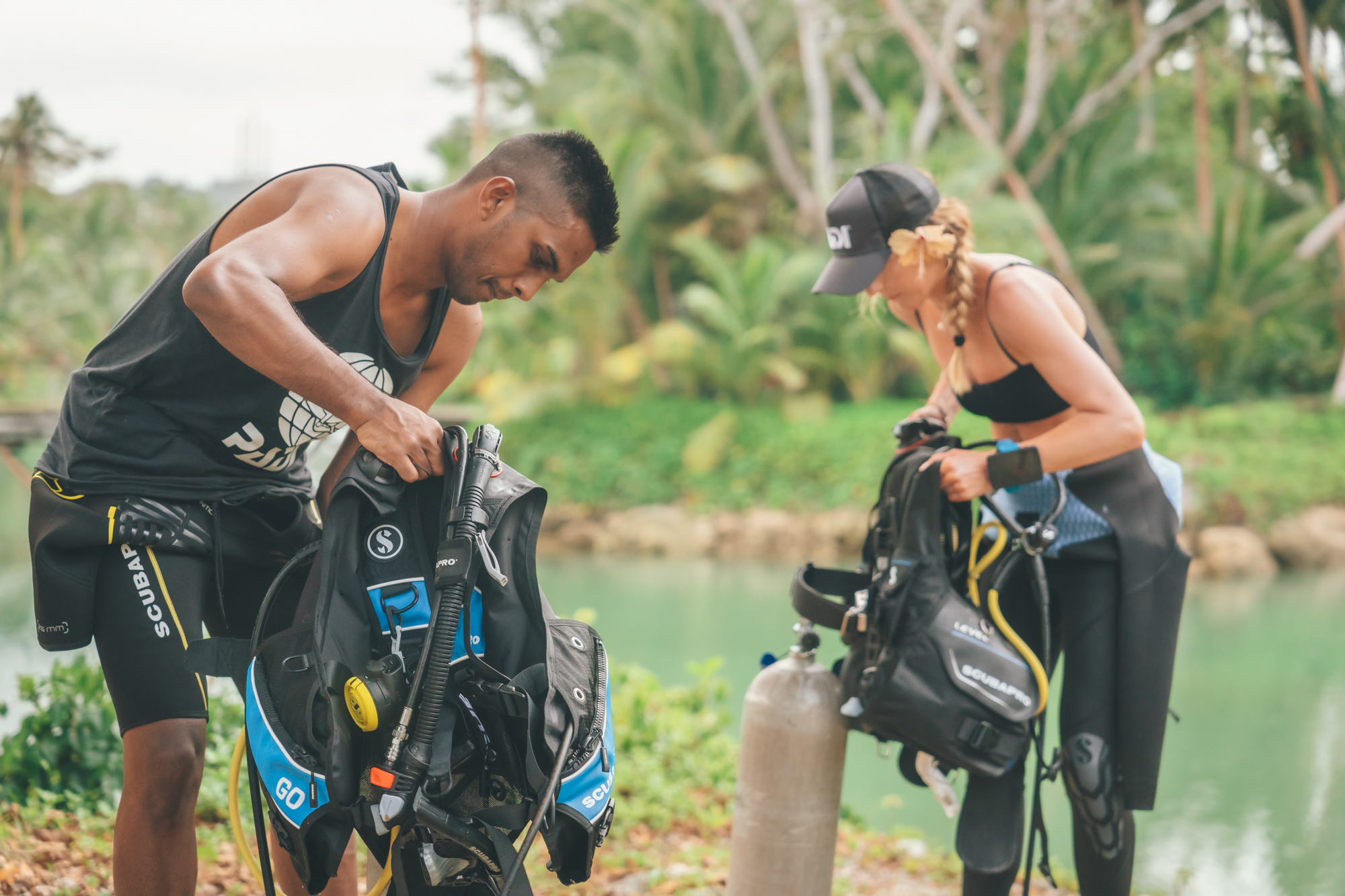 Two divers prepare their scuba gear before a dive in India
