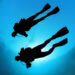 two scuba divers in sillhouette