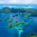 An aerial view of lush green islands tucked among blue bays